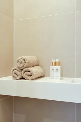 a shelf in a bathroom with towels on it at The Ville in Groet