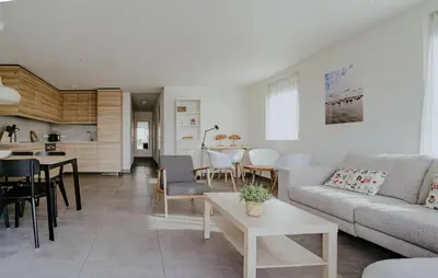 a living room with a couch and a table at Westergeest Luxe in Uitgeest