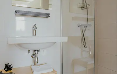 a bathroom with a sink and a shower at Saskerlei in Uitgeest