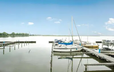 a boat is docked at a dock in the water at Oostergeest 3 6P in Uitgeest