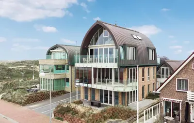 an architectural rendering of a building with a metal roof at Appartement Crab in Egmond aan Zee