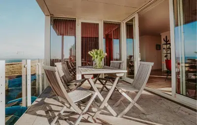 a table and chairs on the balcony of a house at Appartement Crab in Egmond aan Zee
