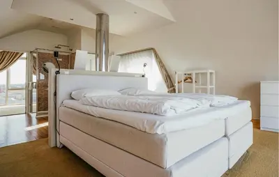 a large white bed in a room at Shrimp in Egmond aan Zee