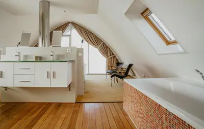 a bathroom with a white bath tub in a attic at Shrimp in Egmond aan Zee