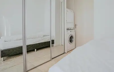 a room with a washing machine and a mirror at Shrimp in Egmond aan Zee
