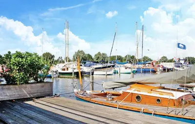 a boat is docked at a dock with other boats at Westergeest 3 6P in Uitgeest