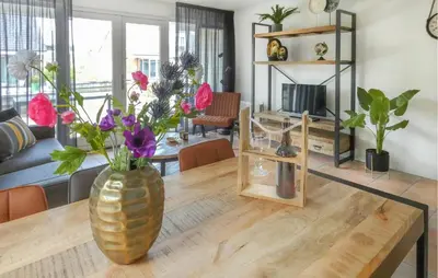 a living room with a vase of flowers on a table at Busch & Dam in Uitgeest