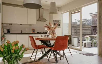 a kitchen with a table and chairs in a kitchen at Sea Bass in Egmond aan Zee