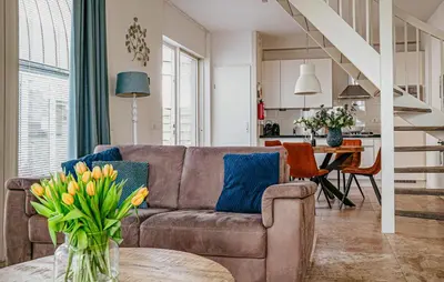 a living room with a couch and a table at Flat Fish in Egmond aan Zee
