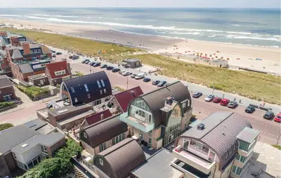 an aerial view of a beach with buildings and cars at Lobster in Egmond aan Zee