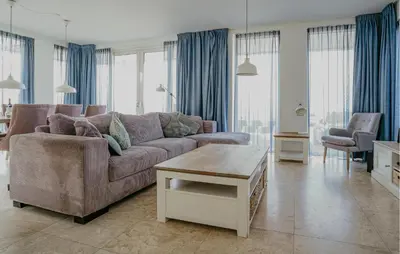 a living room with a couch and a table at Lobster in Egmond aan Zee