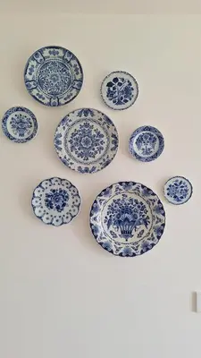 a bunch of blue and white plates on a wall at Studio in Amsterdam Area Horizon Hideaway in Broek in Waterland