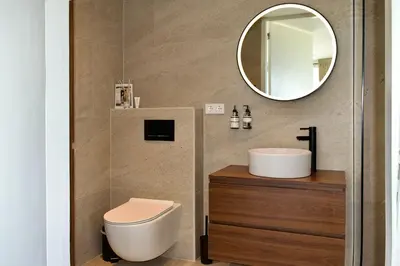 a bathroom with a toilet and a sink and a mirror at Studio in Amsterdam Area Horizon Hideaway in Broek in Waterland