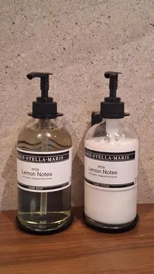 two bottles of soap sitting on a wooden table at Studio in Amsterdam Area Horizon Hideaway in Broek in Waterland