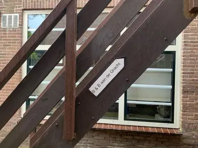 a building with a window with a sign on it at B&B aan de Gracht in Alkmaar