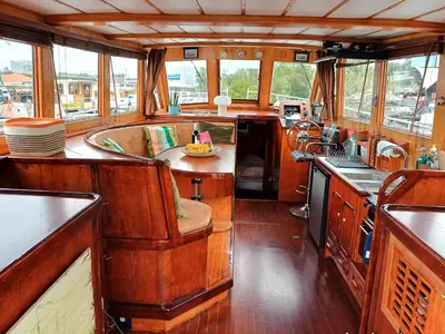 a kitchen and dining area of a train car at Motorjacht At Ease in Amsterdam