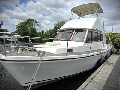 a white boat is docked at a dock at Motorjacht At Ease in Amsterdam