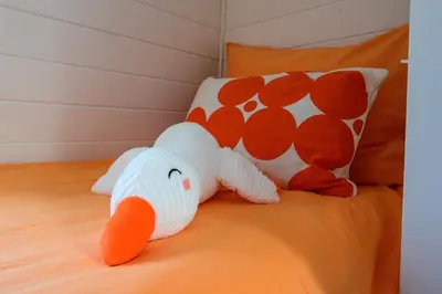 a stuffed elephant toy on a bed with a pillow at 5 O Clock Somewhere in Bergen