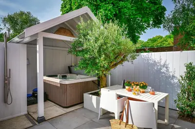 a patio with a white table and a tree at 5 O Clock Somewhere in Bergen