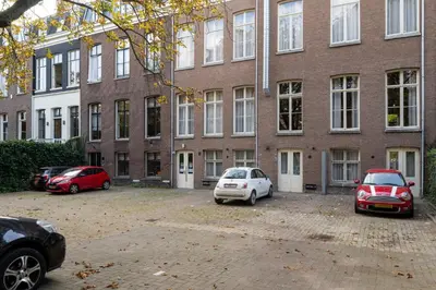 two cars parked in front of a brick building at Boutique Hotel Oosteinde in Amsterdam