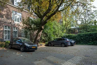 two cars parked in a parking lot next to a tree at Boutique Hotel Oosteinde in Amsterdam