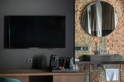 a living room with a flat screen tv on a wall at Boutique Hotel Oosteinde in Amsterdam