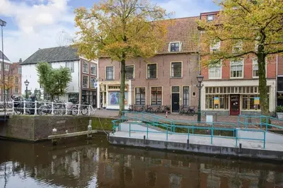 a river in a city with buildings next to a canal at Hoogwaardig afgewerkt loft in oude stadscentrum in Alkmaar