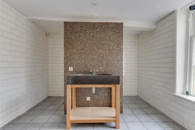 a bathroom with a sink and a brick wall at Hoogwaardig afgewerkt loft in oude stadscentrum in Alkmaar