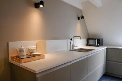 a kitchen with a sink and a counter top at Amersfoort City Center Apartment StadsHart in Amersfoort