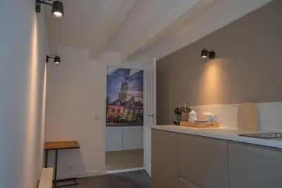 a kitchen with a counter top and a window at Amersfoort City Center Apartment StadsHart in Amersfoort