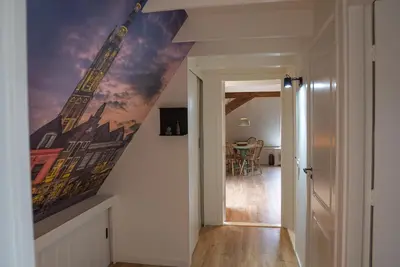 a hallway with a painting of a building on the wall at Amersfoort City Center Apartment StadsHart in Amersfoort