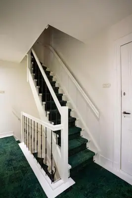 a staircase in a house with green carpet at Amersfoort City Center Apartment StadsHart in Amersfoort