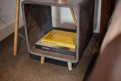 a stack of books in a drawer of a table at Yourbnb Suites Kerkstraat in Amsterdam