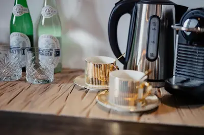 a counter top with two cups and a coffee maker at Yourbnb Suites Kerkstraat in Amsterdam