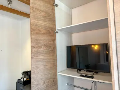 a sliding barn door in a living room with a television at Yourbnb Suites Kerkstraat in Amsterdam