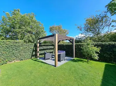 a gazebo sitting in the middle of a lawn at Have a nice stay! - Vakantiehuis Buitenplaats in Noordwijkerhout