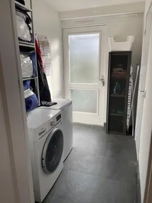 a laundry room with a washing machine and a window at The Duck of Amsterdam in Amsterdam