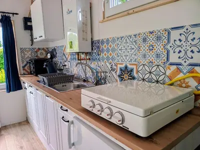 a kitchen with a sink and a stove top oven at Relax Cozy Dirkshorn Stay in Dirkshorn