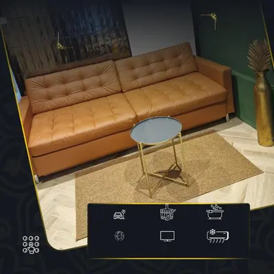 a living room with a brown couch and a table at Tiny room with wellness in Nieuwegein