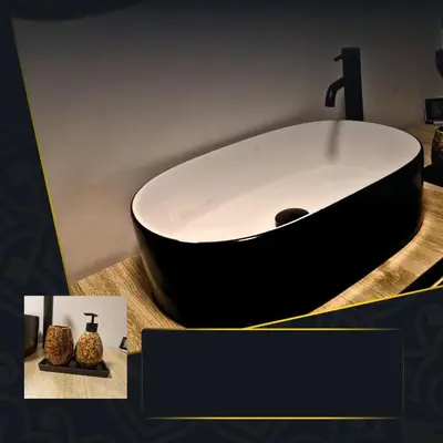 a bathroom with a black and white sink on a counter at Tiny room with wellness in Nieuwegein