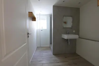 a bathroom with a sink and a mirror at DUINUNDER In de duinen, loopafstand naar 't strand in Noordwijk aan Zee