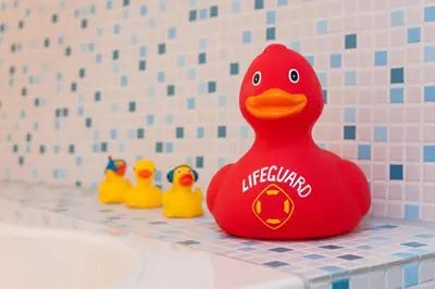 a red rubber duck in a bathroom with other rubber ducks at Houseboat De Cornelia in Amsterdam