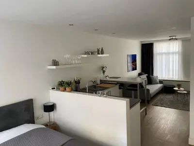 a white room with a kitchen and a living room at Rosies Place in Amsterdam