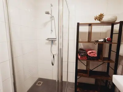a shower with a glass door in a bathroom at Spacious apartment, Canal area, city center in Amsterdam