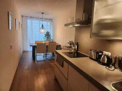 a kitchen with a counter top and a dining room at Spacious apartment, Canal area, city center in Amsterdam