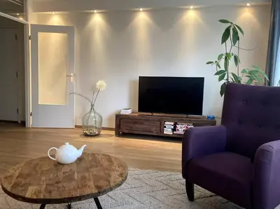 a living room with a tv and a coffee table at Spacious apartment, Canal area, city center in Amsterdam