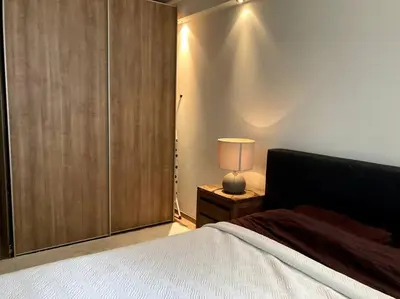 a bedroom with a bed and a lamp on a night stand at Spacious apartment, Canal area, city center in Amsterdam