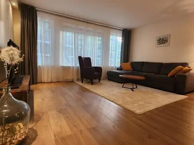 a living room with a black couch and a table at Spacious apartment, Canal area, city center in Amsterdam