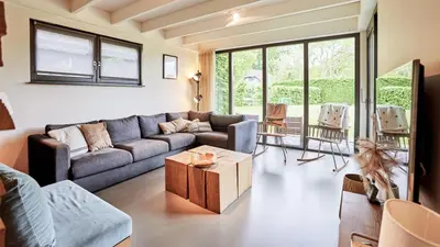 a living room with a couch and a table at Dutchen Duynvoet Suites in Schoorl