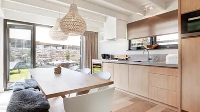 a kitchen and dining room with a table and chairs at Dutchen Duynvoet Suites in Schoorl